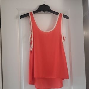 Orange sleeveless blouse with side stitch detail
